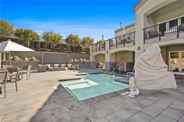 view of swimming pool featuring a swimming pool, fence, an outdoor living space, and a patio