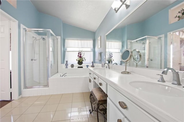 full bathroom featuring vaulted ceiling, a sink, a shower stall, and tile patterned floors