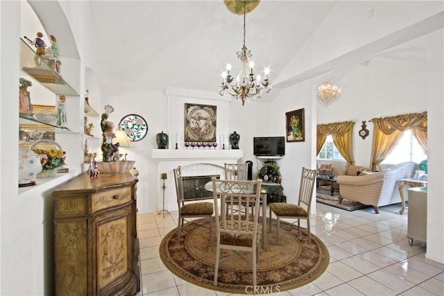 sitting room with lofted ceiling, light tile patterned floors, an inviting chandelier, and a tile fireplace