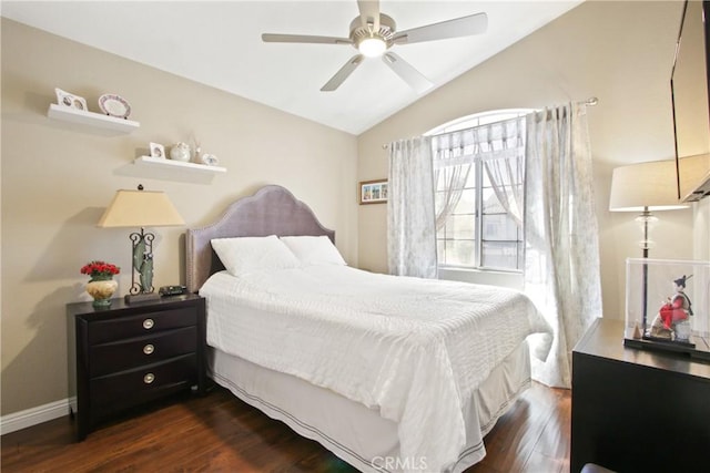 bedroom featuring lofted ceiling, dark wood finished floors, a ceiling fan, and baseboards