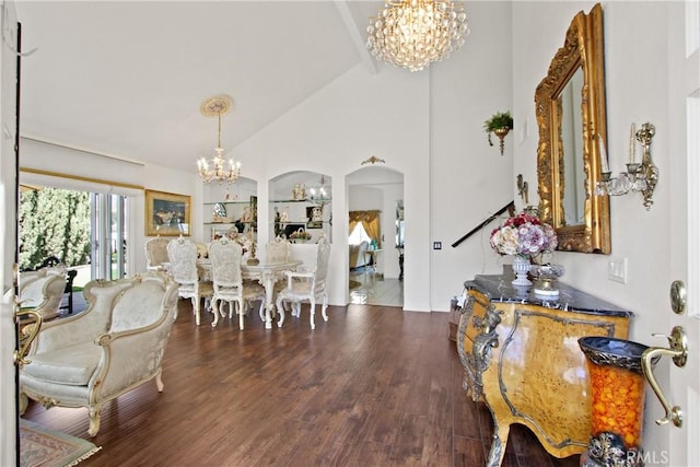 dining area featuring high vaulted ceiling, arched walkways, a notable chandelier, and wood finished floors