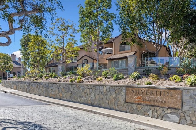 view of front of property featuring a tile roof and stucco siding