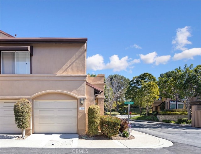 view of front of property with a garage and stucco siding