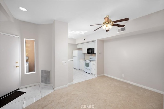 interior space featuring light carpet, visible vents, and baseboards