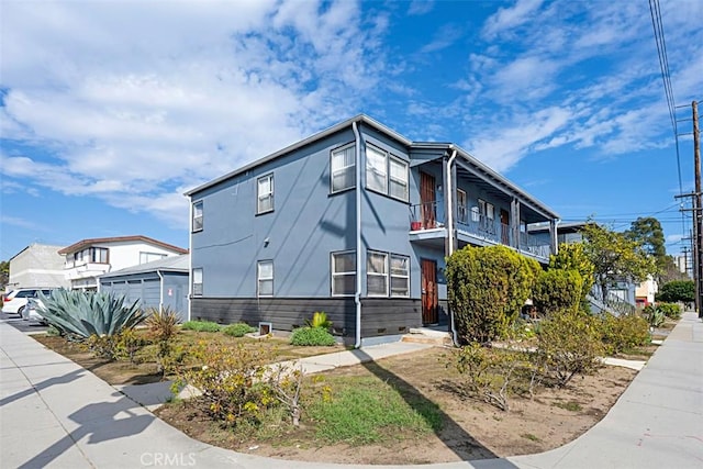 view of front of home with a garage and a balcony