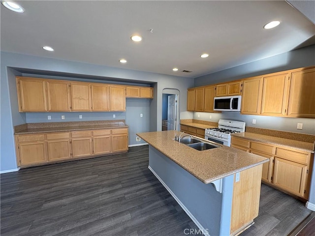 kitchen with dark wood-style floors, recessed lighting, white appliances, and a sink