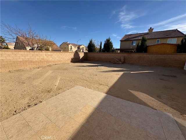 view of yard featuring a patio area and a fenced backyard