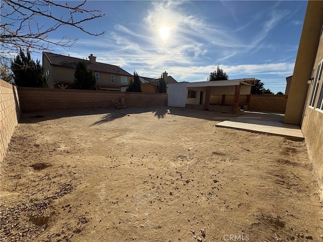 view of yard with a fenced backyard and a patio