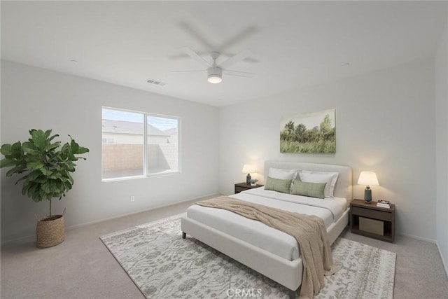 carpeted bedroom with ceiling fan, visible vents, and baseboards