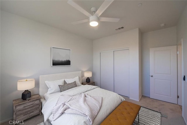 carpeted bedroom featuring a closet, visible vents, ceiling fan, and baseboards