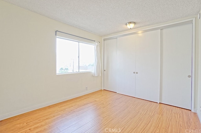 933 New Depot St Unit 6 & 7, Los Angeles, CA 90012 - unfurnished bedroom with wood finished floors, a textured ceiling, and a closet