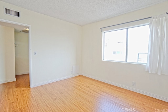 933 New Depot St Unit 6 & 7, Los Angeles, CA 90012 - empty room with light wood-style flooring and a textured ceiling
