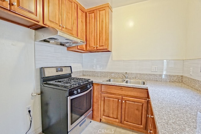 933 New Depot St Unit 6 & 7, Los Angeles, CA 90012 - kitchen featuring stainless steel gas range, under cabinet range hood, backsplash, light stone counters, and brown cabinets