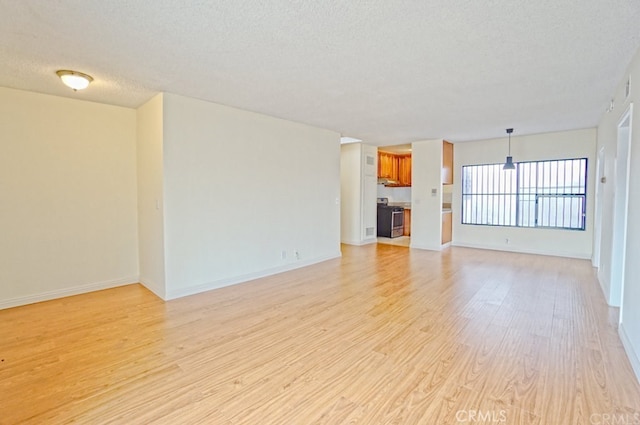 933 New Depot St Unit 6 & 7, Los Angeles, CA 90012 - unfurnished living room featuring light wood finished floors and a textured ceiling