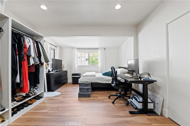 bedroom featuring wood finished floors and recessed lighting