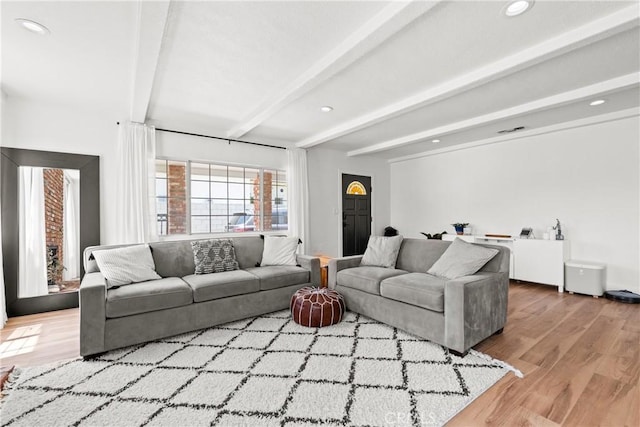 living room featuring recessed lighting, visible vents, beam ceiling, and wood finished floors