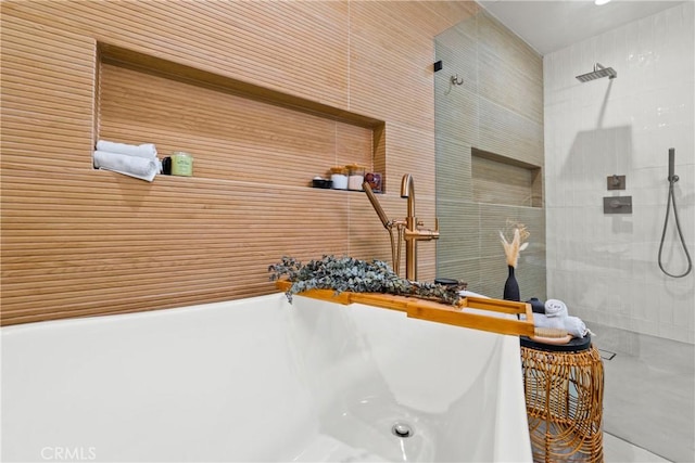 full bathroom featuring a freestanding tub and a tile shower