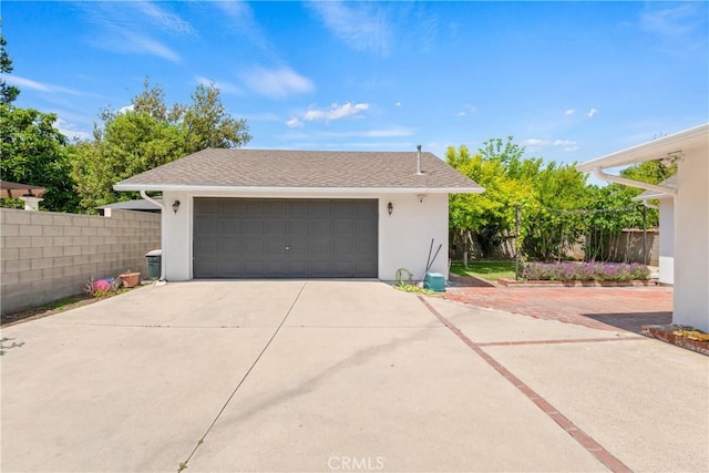 detached garage featuring fence