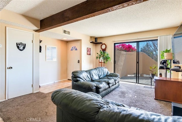 living area featuring a textured ceiling, carpet flooring, visible vents, baseboards, and beam ceiling