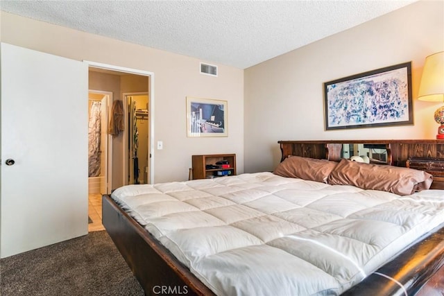 carpeted bedroom with visible vents and a textured ceiling