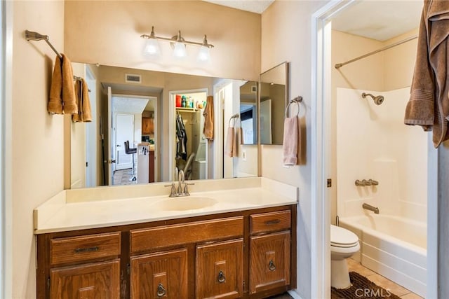 full bath featuring visible vents, toilet, washtub / shower combination, vanity, and tile patterned floors