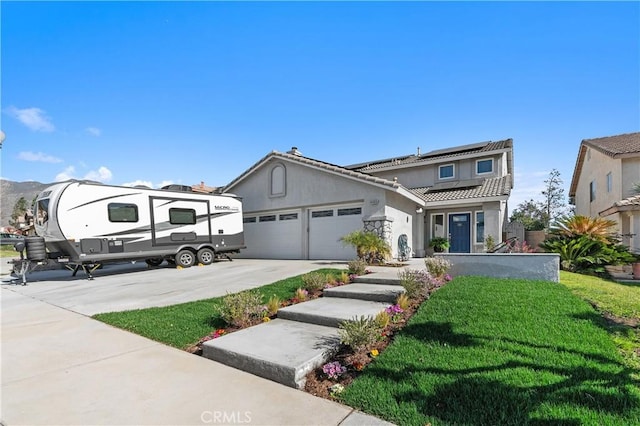 view of front of property featuring concrete driveway, a tiled roof, an attached garage, roof mounted solar panels, and stucco siding