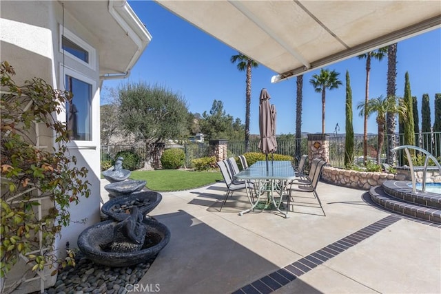 view of patio with outdoor dining area and fence