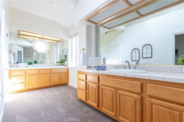 full bath featuring carpet flooring, vaulted ceiling, and vanity