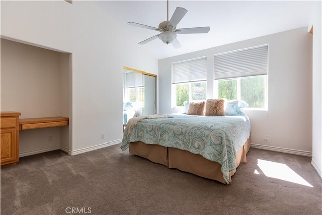 bedroom featuring baseboards, a ceiling fan, built in study area, carpet, and a closet