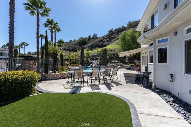 view of patio / terrace featuring outdoor dining space and fence