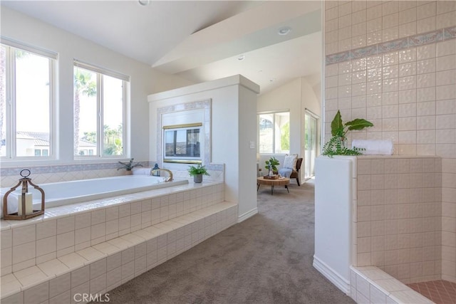 full bath with lofted ceiling, tiled shower, and a garden tub