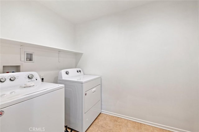 washroom featuring laundry area, washing machine and clothes dryer, and baseboards