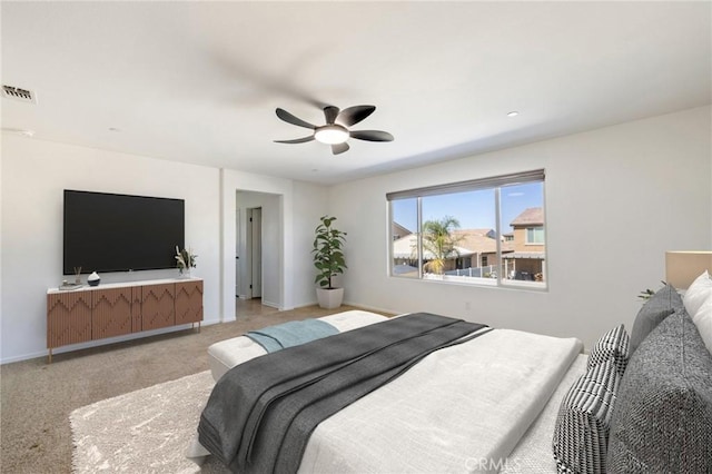 bedroom with light carpet, a ceiling fan, visible vents, and baseboards