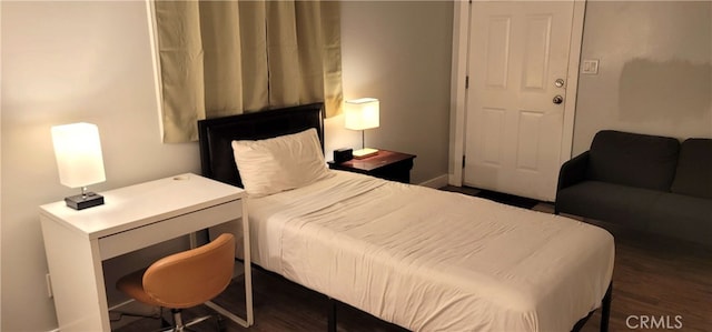 bedroom featuring dark wood finished floors