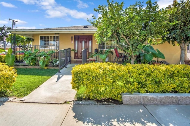 view of front of home with covered porch and stucco siding