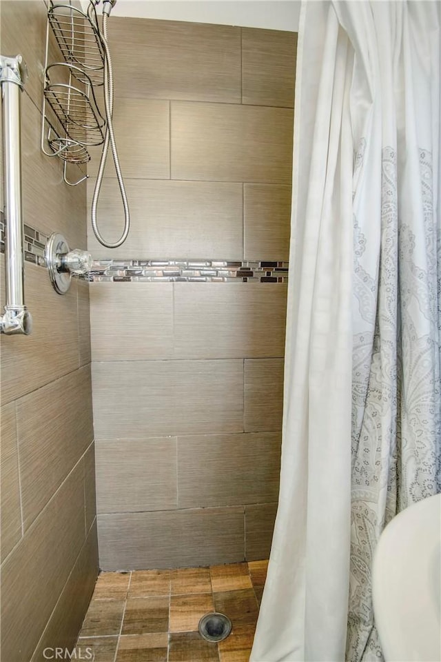 bathroom with tiled shower