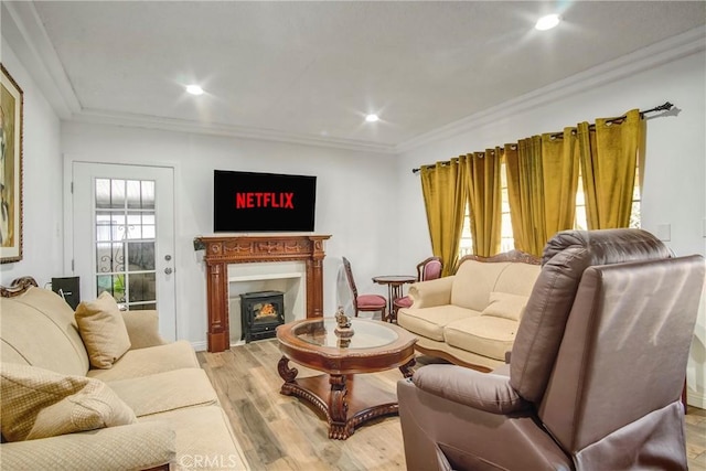 living room featuring recessed lighting, crown molding, and light wood-style flooring