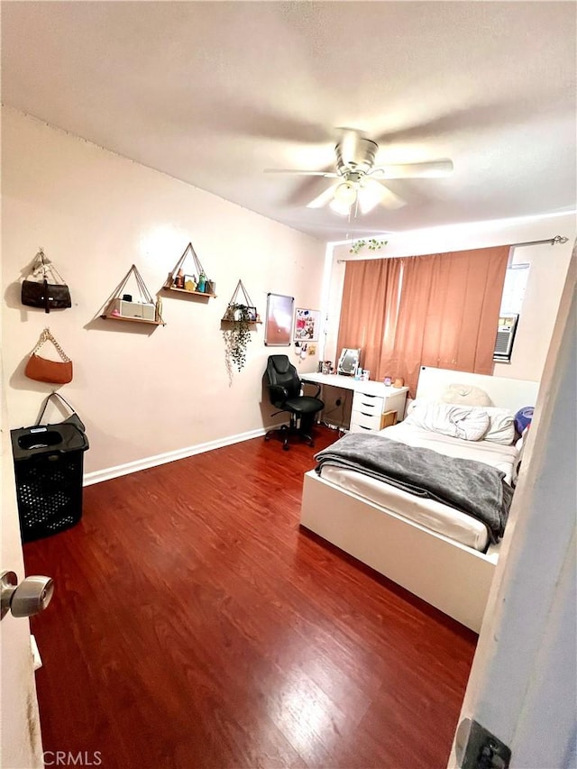 bedroom with a ceiling fan, baseboards, and wood finished floors