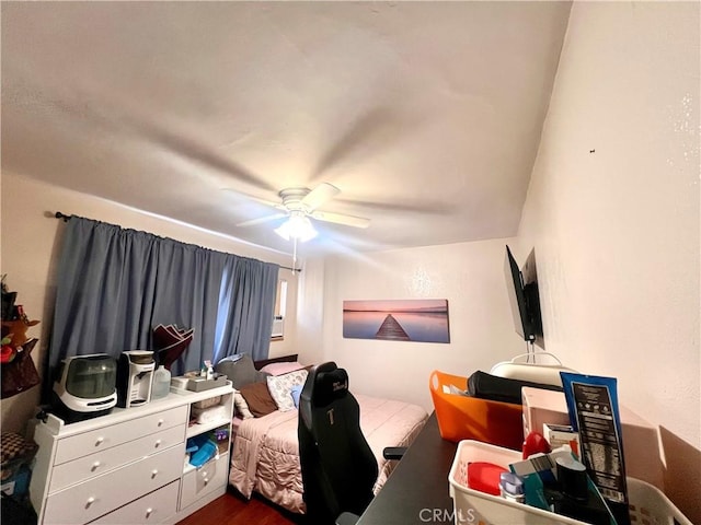 bedroom with a ceiling fan and dark wood-style flooring