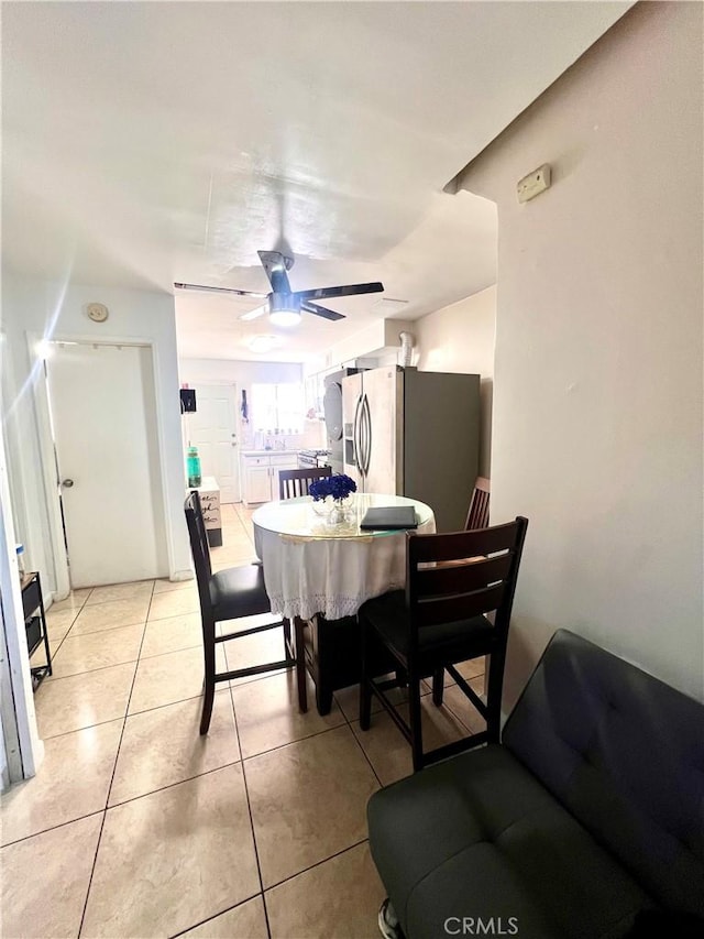 dining space featuring light tile patterned floors and a ceiling fan