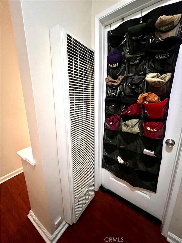 interior details with a heating unit and wood finished floors