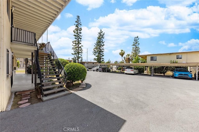 partially covered parking lot featuring stairs