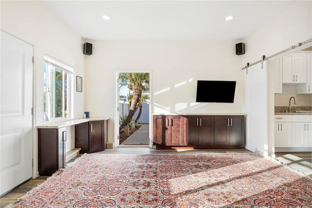 17846 Palora St, Encino, CA 91316 - unfurnished living room with recessed lighting, a barn door, and a sink
