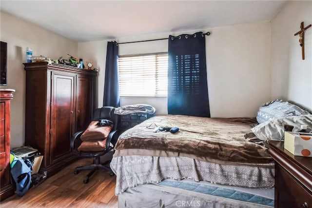 bedroom featuring wood finished floors