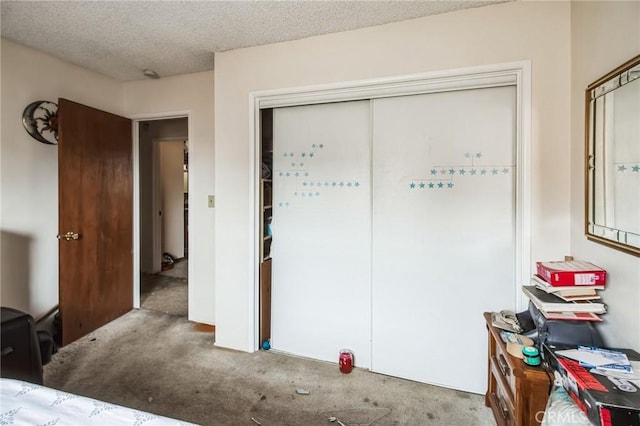 bedroom with a textured ceiling and a closet