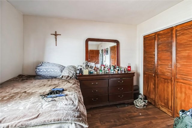 bedroom featuring a closet and dark wood-style flooring