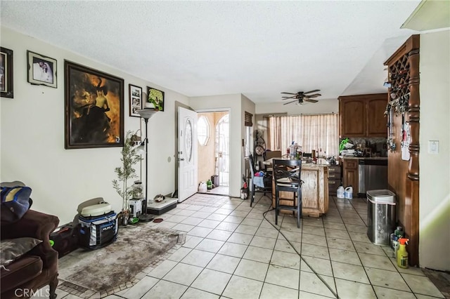 interior space featuring ceiling fan, plenty of natural light, and light tile patterned floors