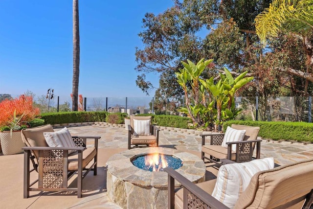 view of patio featuring an outdoor living space with a fire pit