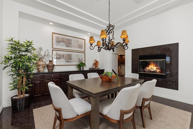 dining room with baseboards, a fireplace, a tray ceiling, and recessed lighting