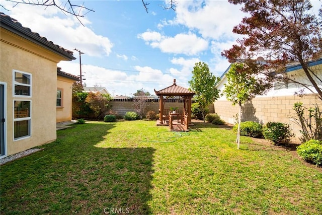 view of yard featuring a fenced backyard and a gazebo